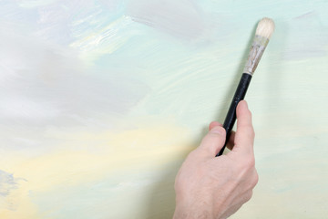 An artist hand painting in studio. Selective focus
