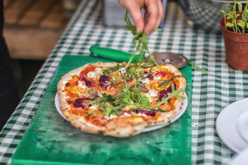 Rocket leaves been added to pizza