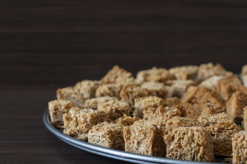 Crackers on a baking sheet on a dark background