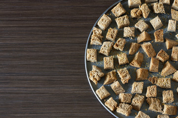 Crackers on a baking sheet on a dark background