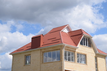 Fototapeta na wymiar House with a roof made of metal sheets