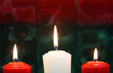 Red and white holiday candles green and red texture background
