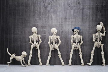 Skeletons pissing at the wall