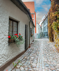 Narrow medieval street in old Riga that is the capital of Latvia and famous Baltic city known of its medieval architecture