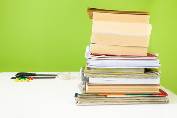 Back to school concept - Student's desk with a pile of books. Close up image.
