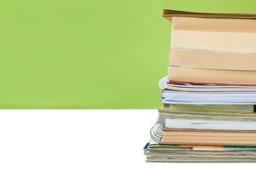 Back to school concept - Student's desk with a pile of books. Close up image.