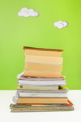 Back to school concept - Student's desk with a pile of books. Close up image.