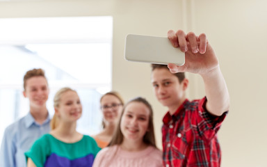 group of students taking selfie with smartphone