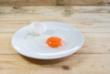 fresh egg yolk on white dish