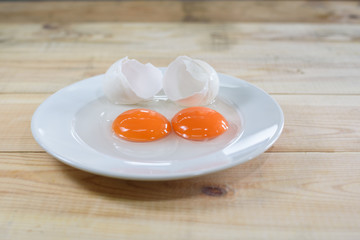 fresh egg yolks on white dish