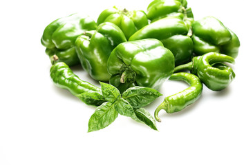 fresh green bell peppers and basil on a white background