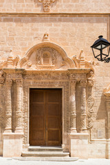 Obraz premium Wooden side door of a christian church with stone pillars