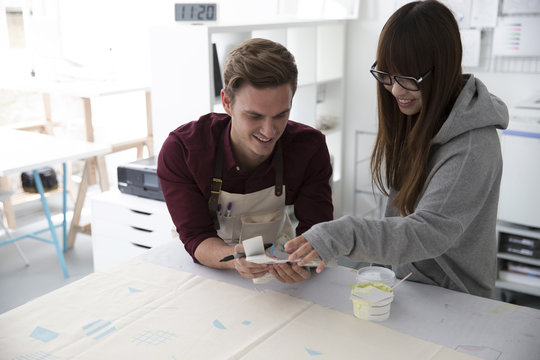 Two People Working In Screen Printing Business