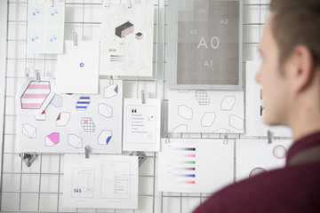 Man Working In Screen Printers Looking At Visual References