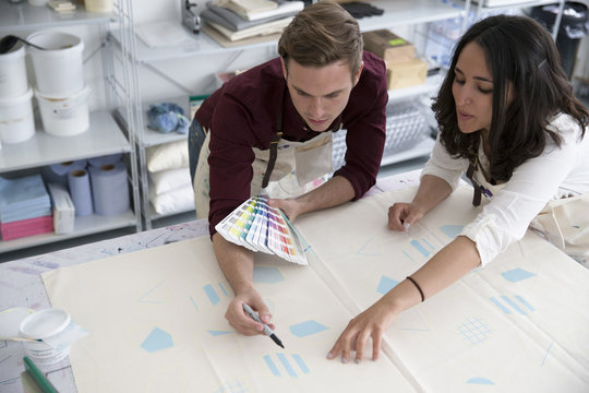 Two People Working In Screen Printing Business