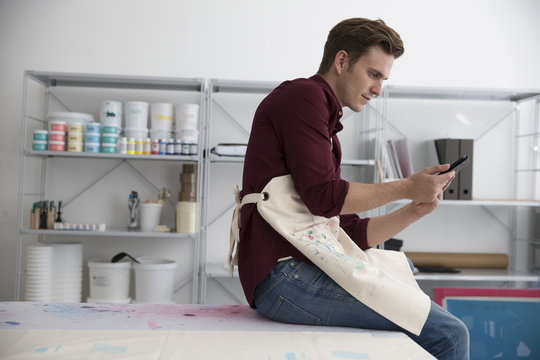 Man Working In Screen Printing Business Using Digital Tablet