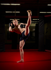Fototapeta na wymiar Training of young kickboxer
