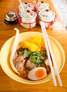 bowl of  delicious noodles with vegetables and boiled egg on woo