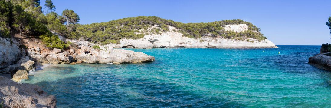 Panoramic view of a bay with crystal blue water with cliffs