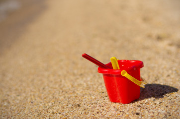 Baby bucket on sand