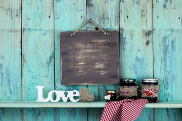 Blank sign hanging over Love and jars of homemade jelly
