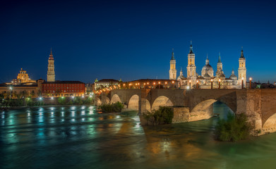 Fototapeta na wymiar Basilica Our Lady Pillar In Zaragoza And the Bridge In Spain At Night