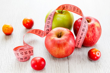 Green and red apples with meter