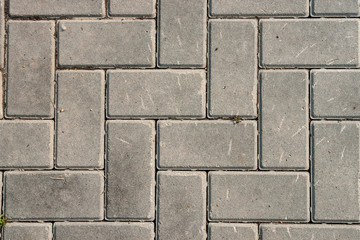 Grey brick stone street road. pavement texture