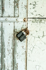 White wooden wall door with the metal lock