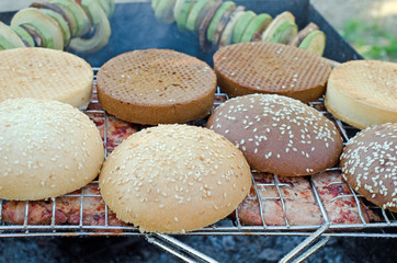 Tasty meat with buns on grill