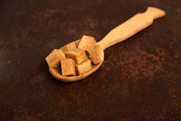 brown Sugar cubes on the wooden spoon