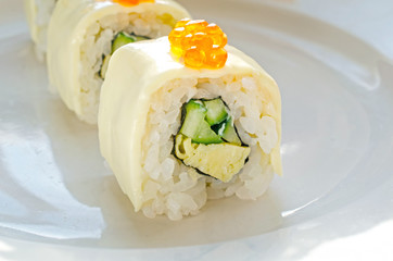 Close up of tasty fresh sushi rolls on plate