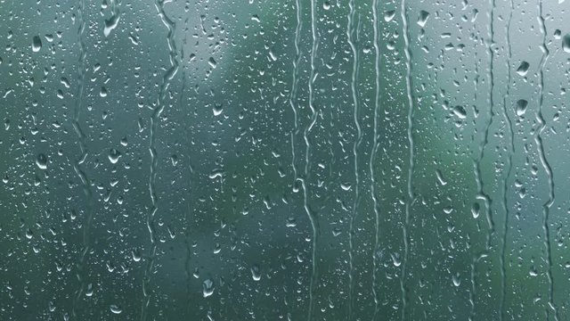 real rain drops sliding on window glass