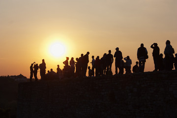 Fototapeta na wymiar silhouette of people on a sunset background