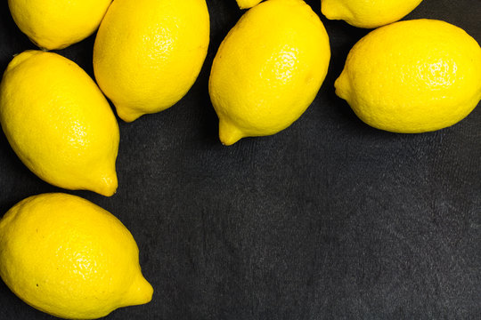 Lemons on a black wooden background