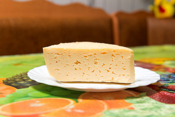A piece of cheese on the kitchen table