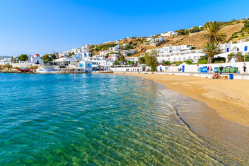 View of beautiful beach with turquoise sea water in Mykonos port, Mykonos island, Greece - obrazy, fototapety, plakaty