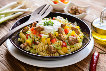 Fusilli pasta salad with fried pork, pepper, green onion, parsley and sour cream dressing