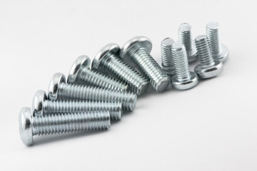 Stainless steel screws on white background