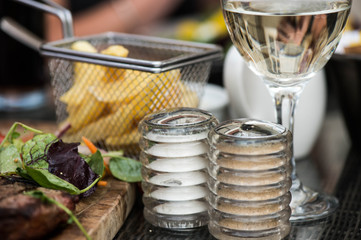 Basket of Fried Chips with a Glass of White Wine and Salt and Pe