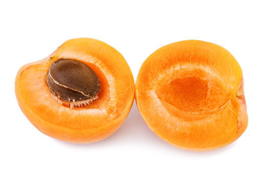 Apricot with fruit kernel on white background. Closeup.