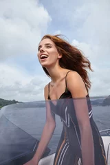 Foto op Canvas Summer vacation - young woman driving a motor boat © ZoomTeam