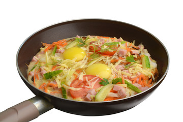 Omelet in a pan with vegetables on a white background