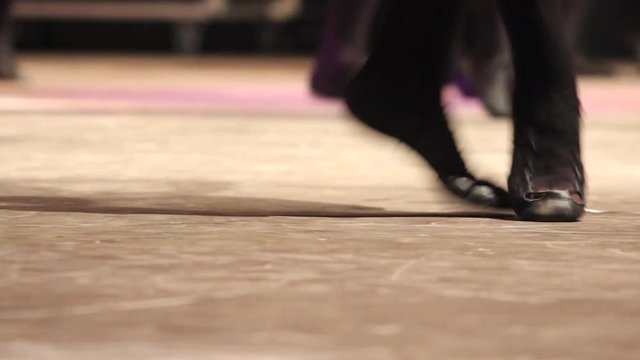Woman doing Irish dance with traditional step shoes. Close up of female dancing feet on stage. Music, tradition and culture of Ireland. Celtic show on wooden floor