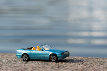 Plakat Blue Car against Water Background