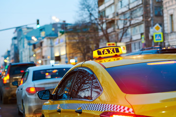 taxi sign on car at evening in the city street © Kadmy