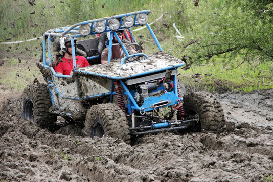 Offroad race - 4x4 car driving through mud