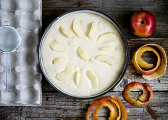 Dough for apple pie before baking on a wooden background
