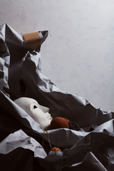 Modern art installation. Traditional Venetian mask on crumpled paper
