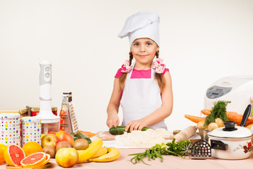 The little girl is preparing in the kitchen
